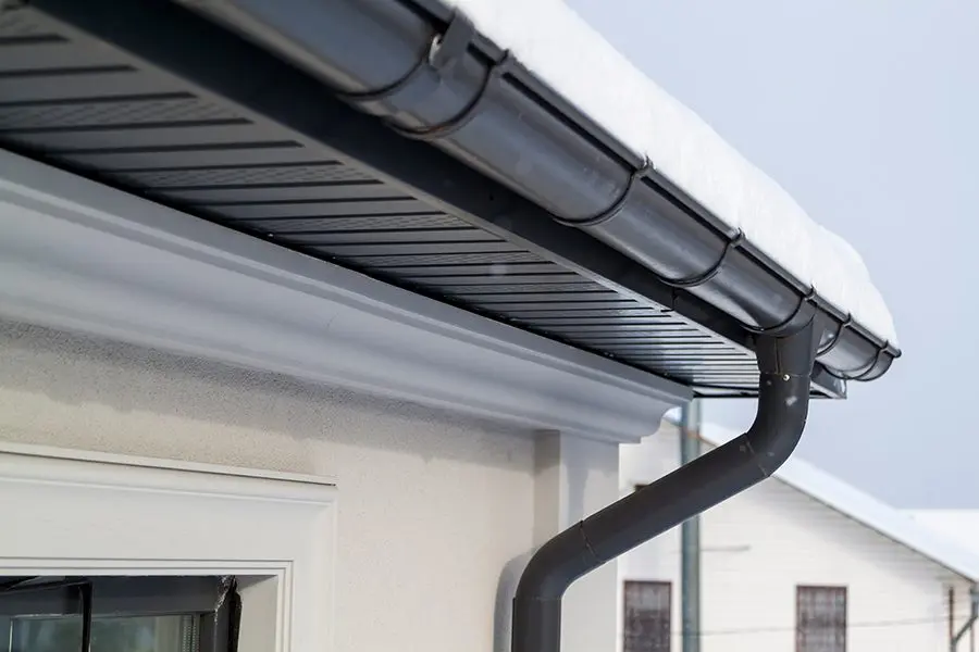 Metal roofing with snowy gutters