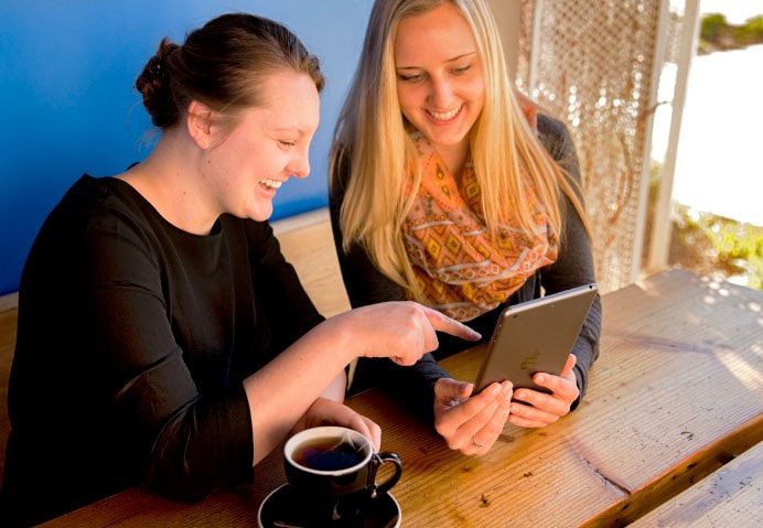 two young women looking at social media in Bozeman, MT