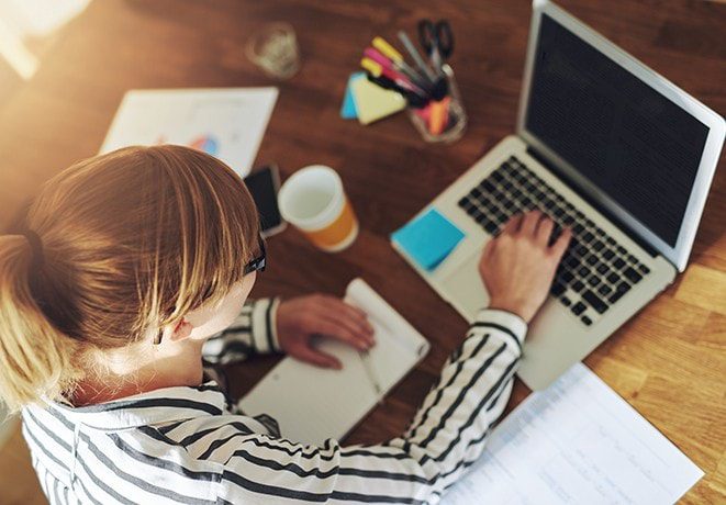 girl in striped shirt on computer