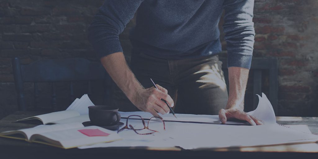 man working on sketching website redesign examples