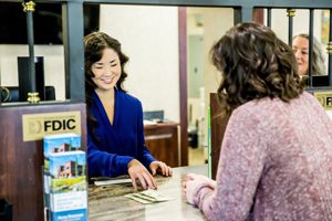 woman teller distributes money