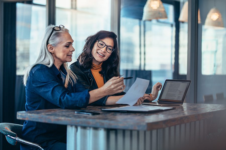 women in coffee shop looking at advertising results